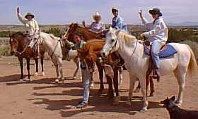 Gals enjoying experienced horseback rides at Makarios Ranch, Santa Fe county New Mexico.  Scenic Galisteo Basin.